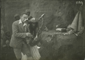 Sir Leonard Woolley holding one of the lyre found in Ur